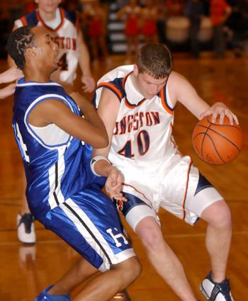 Kingston's matt Poole drives against Harriman's Patrick Davis.