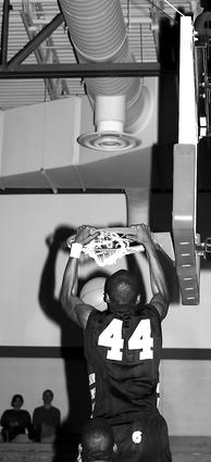 Millington's Jermaine Dailey jams home the ball.