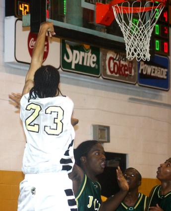 Millington's Carl Fields drops off a three pointer against JCM.