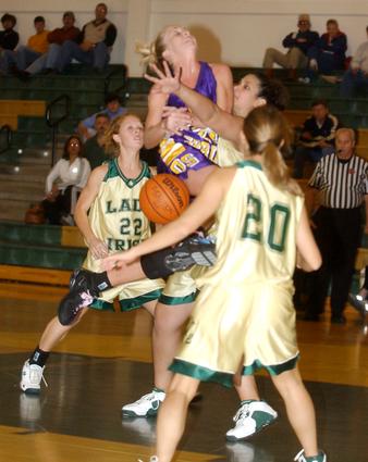 Kara Monk is mugged on her way to the hoop.