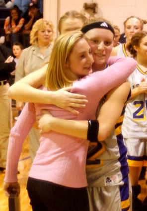 Laura Hall receives a hug from Jessie Hackworth after Friday's ceremony.