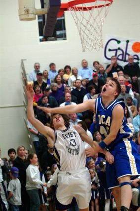 Starting his final home game, senior Gabe Pigg scores the 1st 2 points of the game