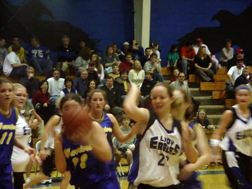 Keisha Chandler (white 22) fights for an offensive rebound