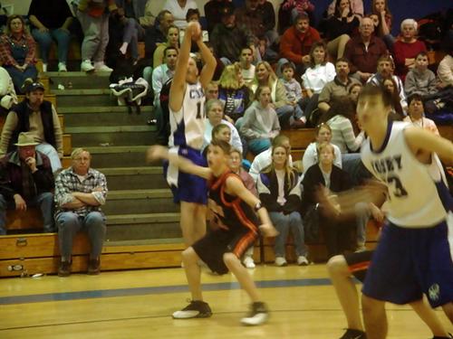 Todd Jenkins (white 10) makes a three point shot