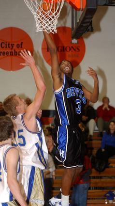 Harriman's Julian Goins puts in a deuce for the Blue Devils.