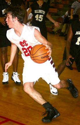 Munford's Jon Sexton looks to head up court against the rival Millington Trojans.