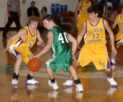 Oliver Springs' Dan Schultz and Cody West look to trap Midway's Jeremy Woody.