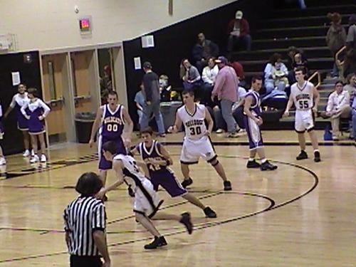 Bulldog #32 Jr. Sean Melton moves the ball as #30 So. Logan Goad looks on.