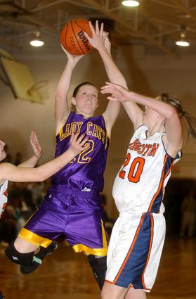 Kingston's Rachel Sitzlar challenges Oliver Springs senior Jessie Hackworth.
