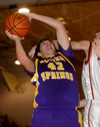 OS junior Adam Carter is fouled while attempting a shot.