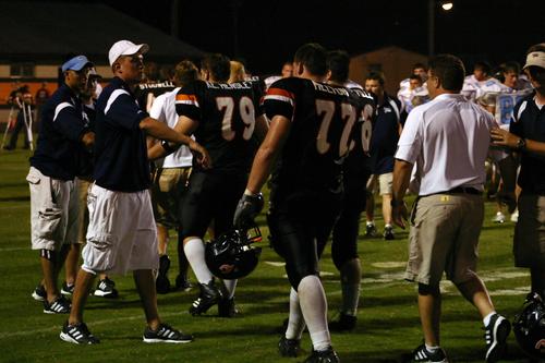 The Jet coaching staff congratulates the Panthers after the game