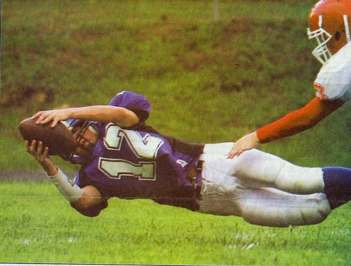 Dustin Buckner #12 recovers a fumble and dives into the endzone.