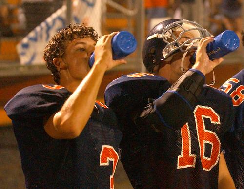 Kingston teammates Landon Kardin and Kyle Adams take a sip of H2O.