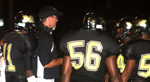 Trojan offensive coordinator Chris Michael discusses the next play with his unit.