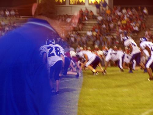 The Tigers line up on defense as Coach Norval watches from the sidelines.