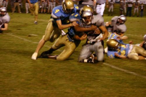 #11 Bostaph and #4 Young lay a big hit on the White Co runner