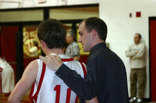 Coach Nathan Powell gives instructions to #10 Myles Parris