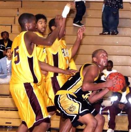 Hixson- Keeven Addison tries to get shot off in the paint Friday night at Tyner