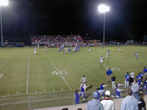 Coach Adams and Coach Gilmer watch the action from the sidelines.