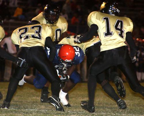 Trojan defense surrounds Aaron Crawford for a stop.