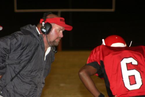 Brighton Head Coach Tim Stalling reviews a play with Glass.