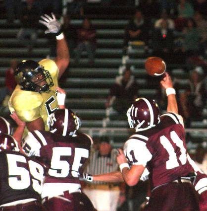 Smith's pass is under pressure by Trojans.