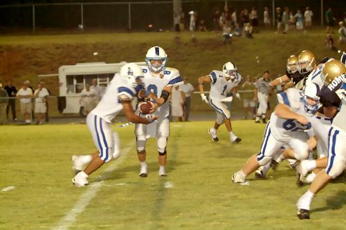 Wilson Cates hands the ball off to Mike Jones Larue