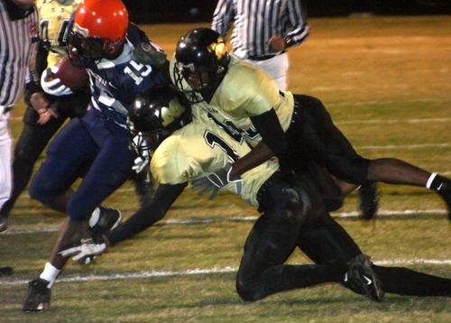 The Trojans push a Ridgeway runner out of bounds.