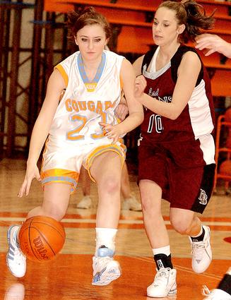Lady Cougar's #23 Christina Howard Drives Toward The Basket As Dobyns - Bennett's #10 Jill Childress Gives Chase.