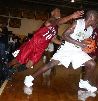 Buck Wakefield attempts a steal on Millington's Mario Justice.