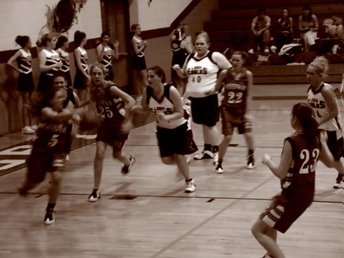 Lindsey Hall (white center) chases after a loose ball