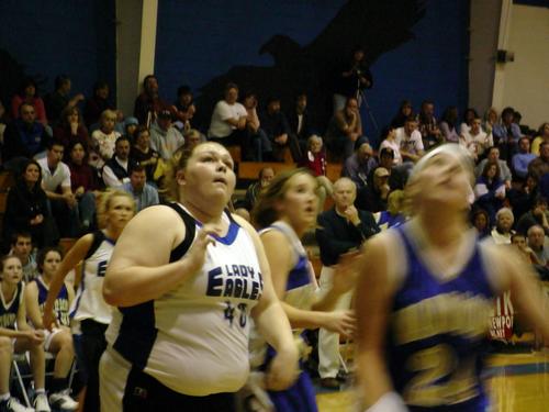 Mindy Hunt (white 40) lands a lay-up after recovering a rebound