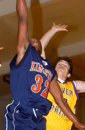 Oliver Springs' Cody West tries to block the shot of Kingston's DeAngelo Knaff.
