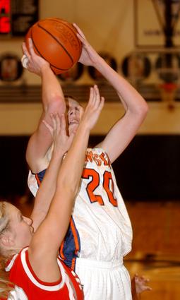Kingston's Rachel Sitzlar shoots with a hand in her face.