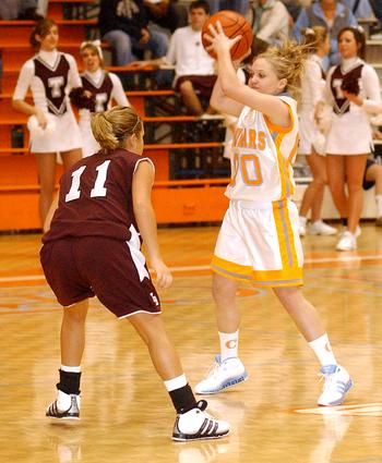 Sullivan Central's #00 Andrea Johnson gets ready to make the pass as Tennessee High's #11 Danielle Sharrett applies a little pressure.