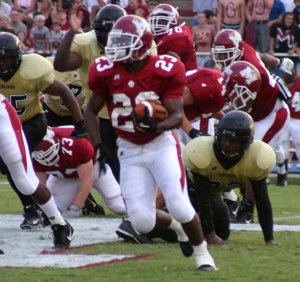 Munford's Malcolm Walker looks for running room.