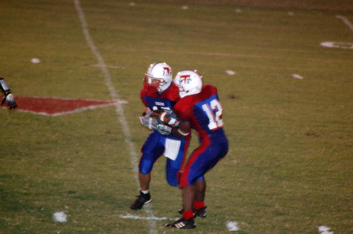 Marco (#12) hands off to Bubba (#15)