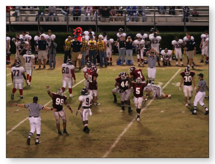 Trojans celebrate coming up with the final interception to ice the game.
