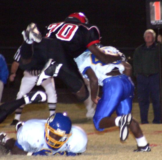 Brighton defensive end Theron Kadri leaps to make a tackle.