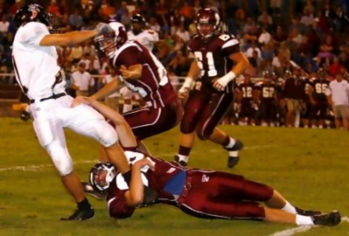 Tennessee High's Matt Fleenor (22) has a lock on Elizabethton's Derek Carr (21) legs to stop a screen play from becoming a major gain. The Viking's Alan Hull (83) gets in on the tackle.