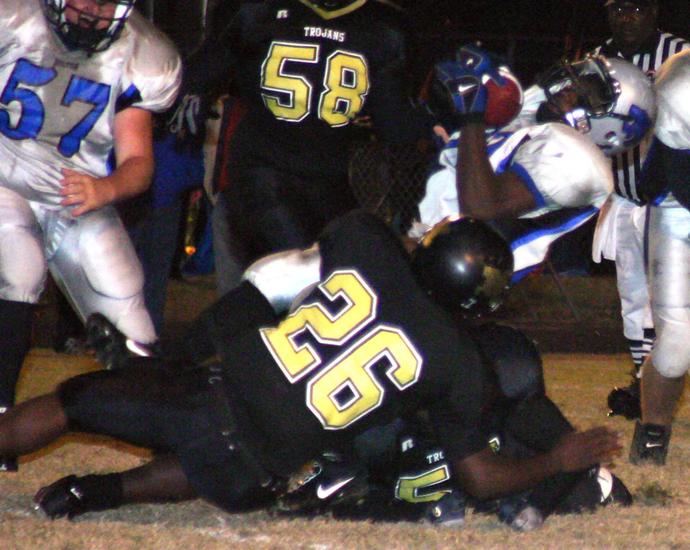 The Trojans stop the ball carrier.