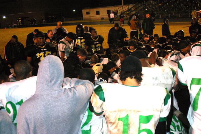Both teams meet at midfield for a prayer.