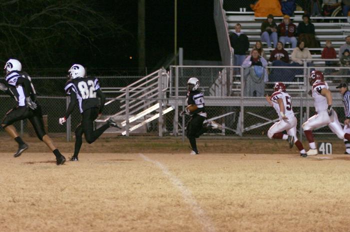 SS's Justin Day and Michael Newbern escort Jontamion Forrest on a 50 yd run