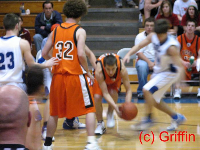 Cody Dixon (orange 15) scrambles to control the ball