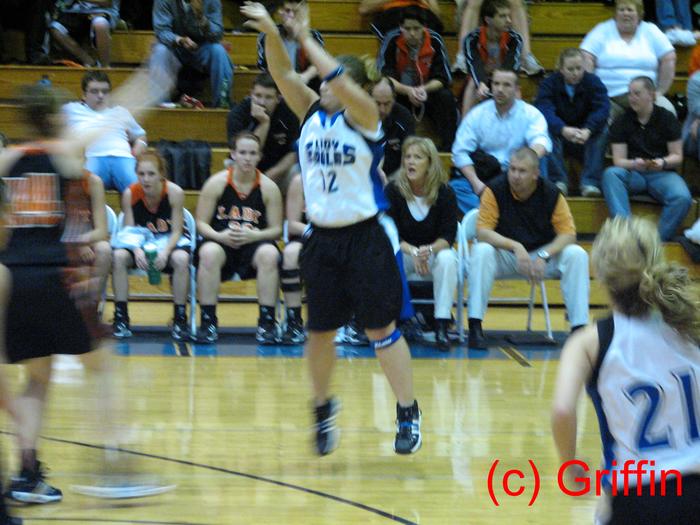 Kalsea Mantooth (white 12) shoots from the three-point line