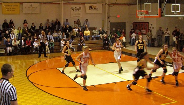 Santa Fe 's Rachel Preist, Lindsey Sewell, Lauren Gardner, and Macenze White scoring her 1000th point againts MTC. (No roster available)