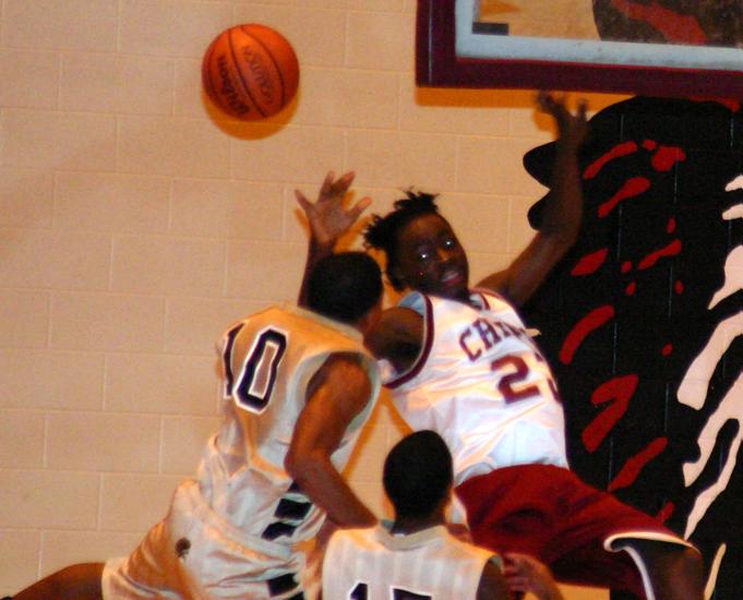 Trojan Trey Woods fouls White during the second quarter.