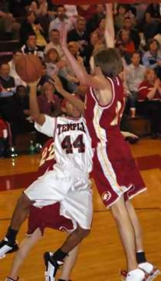 Temple's Dee Newsom takes a shot over Nicl VanHorn of Grace.