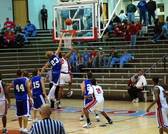 Harpeth's Trey Caruthers goes up high to block an Owensboro shot