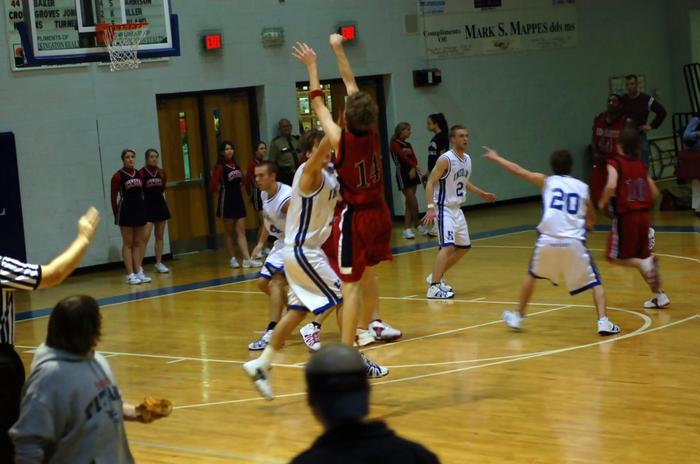 Red Hawks Michael Jeppsen puts up a shot as Harpeth's Tyler Caruthers defends